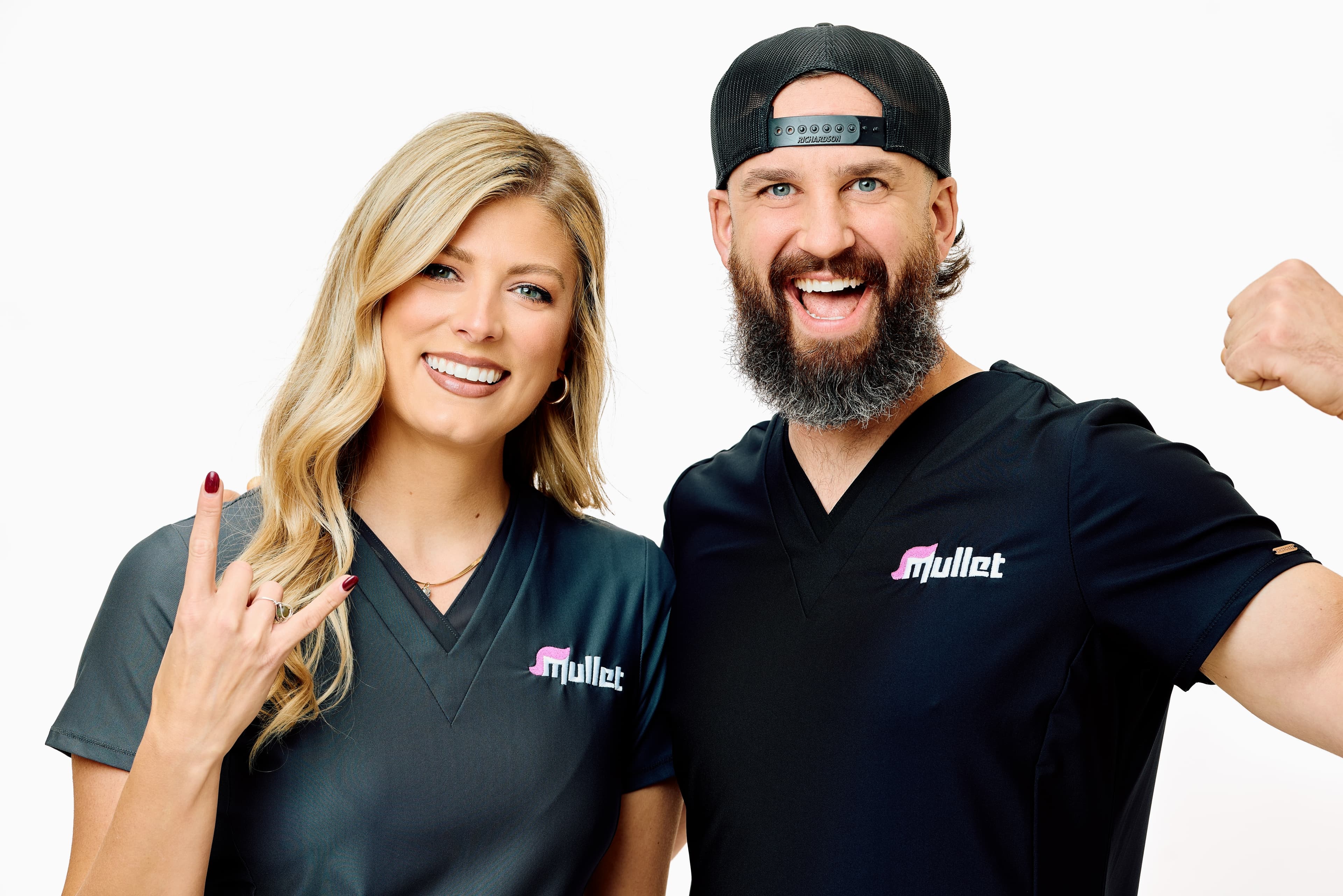 Kelley Johnson and Kyle Morey-Leber wearing Mullet scrubs.